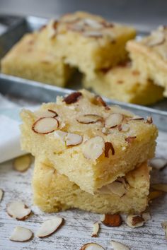 almond bars stacked on top of each other with one slice cut out and another half eaten