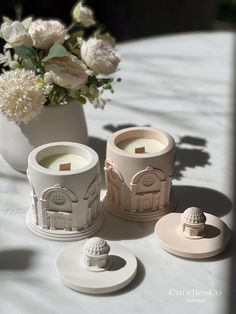 three candles sitting on top of a white table