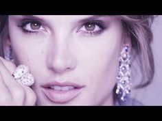 a close up of a person with jewelry on her face and hands near her face