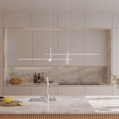 a kitchen with marble counter tops and white cabinets, hanging lights over the sink area