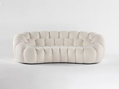 a white couch sitting on top of a white floor