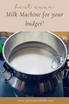 a metal pot filled with milk sitting on top of a stove