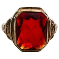 Crafted in 1950, this mid-century gem from American jewelry manufacturers Budlong Docherty & Armstrong, Inc features an emerald-cut synthetic ruby measuring approximately 2.00 carats set in a 10kt yellow gold band with delicate piercing. Marked "BDA" and "10K" Red Emerald-cut Fine Jewelry, Heirloom Red Emerald-cut Jewelry, Luxury Collectible Art Deco Ruby Ring, Vintage Multi-stone Ruby Ring In 14k Gold, Antique 14k Gold Ruby Ring With Multi-stone, American Jewelry, Jewelry Manufacturers, Ruby Ring, Emerald Cut