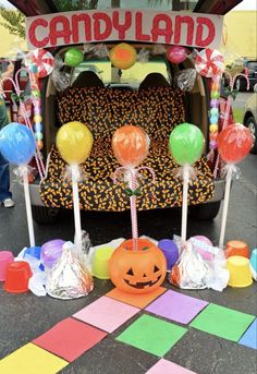 a candy cart decorated for halloween with pumpkins and candies