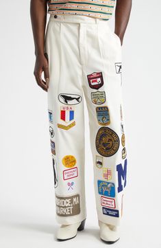 Classic workwear from the '40s and '50s serves as the model for these cotton-canvas pants detailed all over with vintage and reproduction-vintage patches. 29" inseam; 22" leg opening; 15" front rise; 17 1/2" back rise (size 34) Zip fly with button-tab closure Side-seam pockets; back welt pockets 100% cotton Dry clean Imported Designer Clothing Kapitol Clothing, Pants Pocket Design, Patches Pants, Unisex Clothing Fashion, Usa Clothes, Pants Embroidery, Patch Clothes, Classic Workwear, Patch Pants