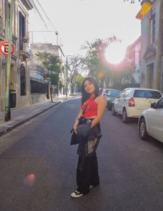 a woman standing in the middle of an empty street