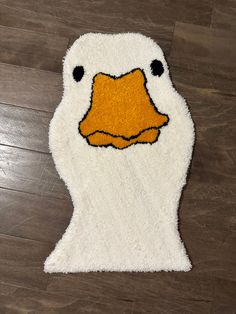 a white duck rug with an orange beak