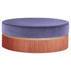 a round ottoman with purple velvet and copper trim