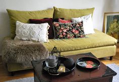 a living room filled with furniture and pillows