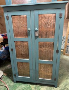 a blue cabinet sitting on top of a floor