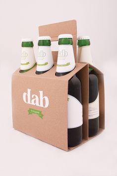 four bottles of dab are in a cardboard box