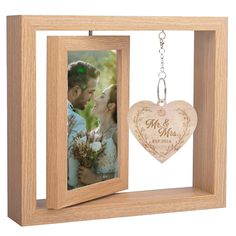 a wooden photo frame with a heart hanging from it