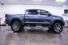 a large gray truck parked in a garage