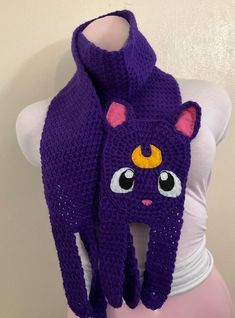 a purple knitted scarf with an evil cat on it