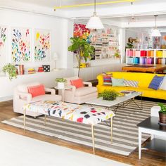 a living room filled with lots of furniture and colorful accessories on top of a hard wood floor