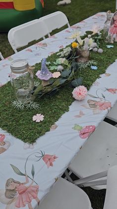 the table is covered with moss and flowers