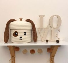 a stuffed animal is sitting on top of a shelf next to the word love written above it