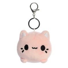 a pink cat keychain with black eyes and ears on it's face