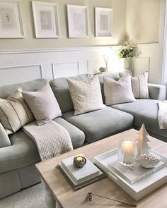 a living room filled with lots of furniture and pillows on top of a wooden table