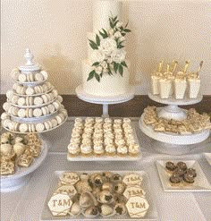 a table topped with lots of desserts and cakes