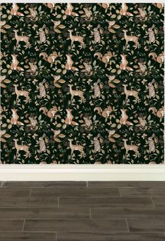 an animal themed wallpaper with deers and leaves on it in front of a wooden floor