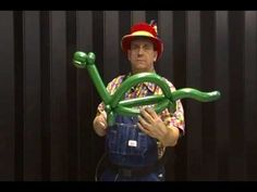 a man holding an inflatable balloon with a fireman's hat on