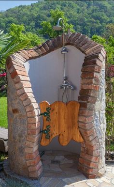 an outdoor shower in the middle of a garden