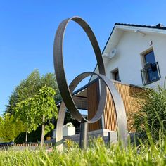 a metal sculpture in front of a house