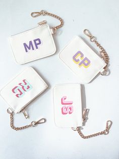 four small purses with initials on them