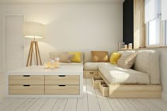 a living room filled with furniture and lots of wood flooring next to a window