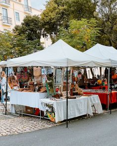 an outdoor market is set up on the street