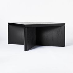 a black table sitting on top of a white floor