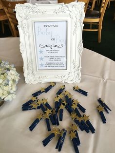 there are many blue and gold stars on the table next to a white framed picture