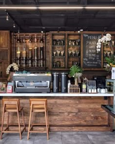 a coffee shop with lots of wooden cabinets and stools in front of the counter