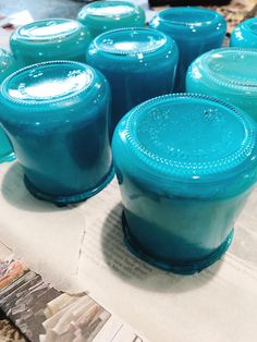 blue jars sitting on top of a piece of paper