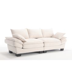 a white couch with pillows on top of it