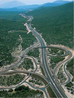 an aerial view of multiple roads in the mountains