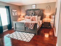 a bed room with a neatly made bed and wooden floors