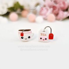 two small tea mugs with faces are sitting next to each other