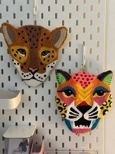 two animal masks are hanging on the wall