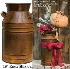 an old rusty milk can with a christmas decoration on top and a rustic style pumpkin in the bottom