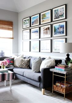 a living room filled with lots of furniture and pictures on the wall above it's couch