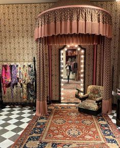 a fancy room with an ornate canopy bed and checkerboard flooring on the walls