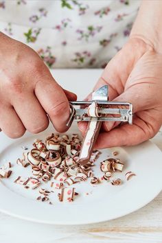 a person is using a pair of tongs to cut up food on a plate