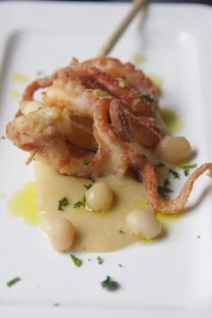 a white plate topped with meat and beans