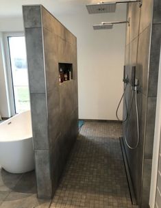 a bathroom with a walk in shower next to a bathtub