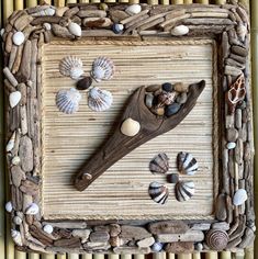 a wooden frame with shells and seashells on it