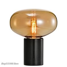 a light that is on top of a black stand with a glass ball in the middle