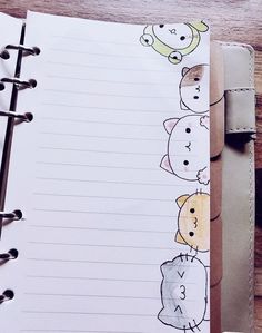 an open notebook with drawings of cats and dogs lined up on top of each other