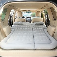 an inflatable mattress is placed inside the back of a car